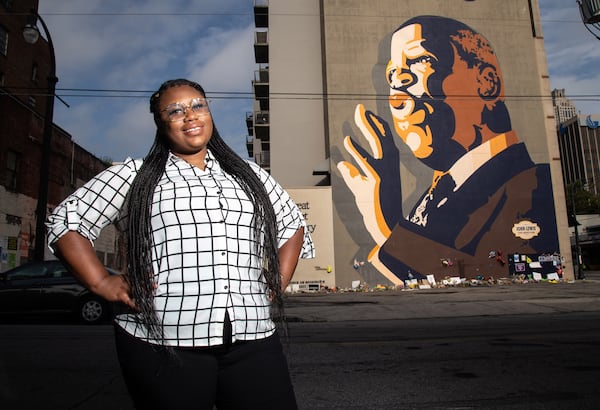 Mary-Pat Hector poses for a photograph in front of the  John Lewis mural on Auburn Ave in Atlanta, August 6, 2020.  STEVE SCHAEFER FOR THE ATLANTA JOURNAL-CONSTITUTION