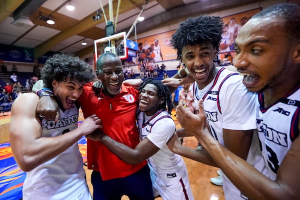 From left, Dayton forward Nate Santos, Dayton head coach Anthony Grant, guard Malachi Smith, guard Hamad Mousa and forward Zed Key celebrate an 85-67 win over UConn in an NCAA college basketball game at the Maui Invitational Wednesday, Nov. 27, 2024, in Lahaina, Hawaii. (AP Photo/Lindsey Wasson)