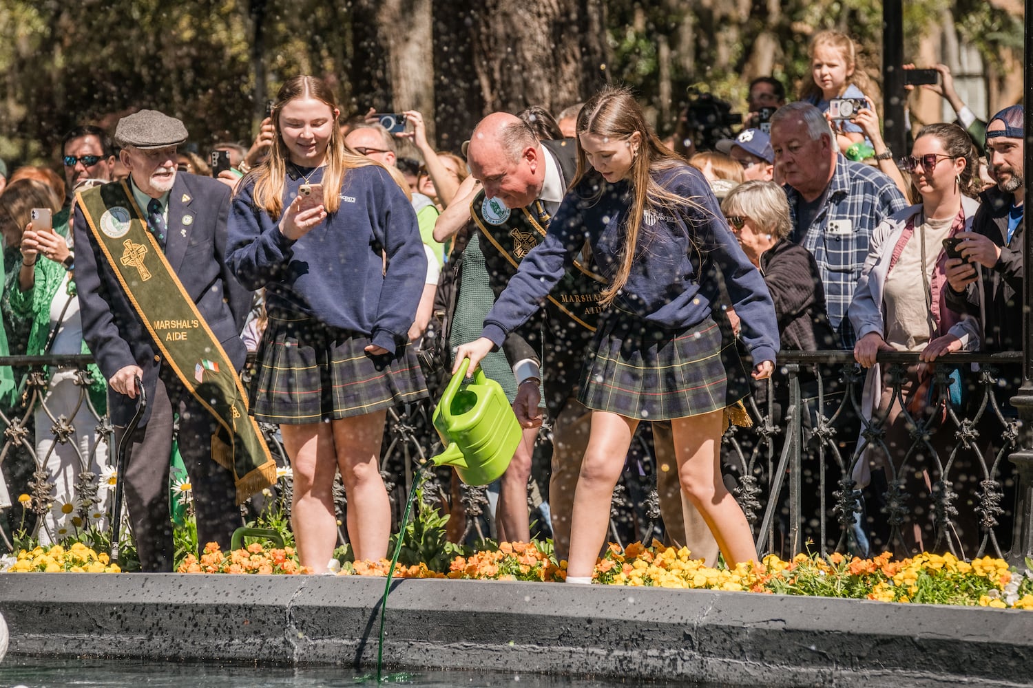 Members of the 2025 St. Patrick’s Day Parade Committee pour green dye into the fountain in Forsyth Park on March 7, 2025 in Savannah, GA. The dying of the fountain marks the beginning of the city’s St. Patrick’s Day festivities. (Justin Taylor/The Atlanta Journal Constitution)