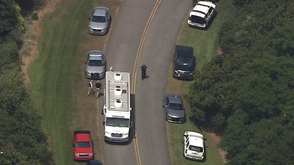 Several police cars lined up at the State Botanical Garden due to a reported "violent suspect."