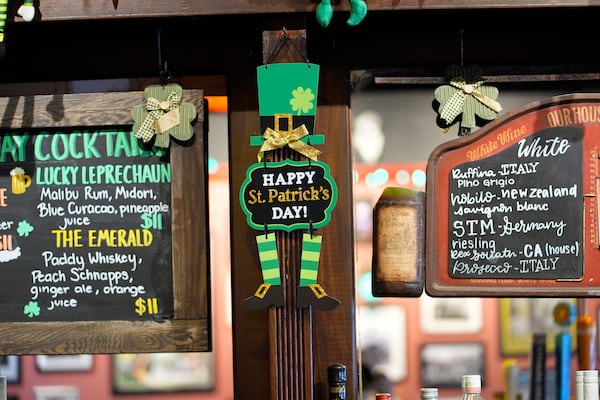 A St. Patrick's Day decoration is displayed between two drink menus at the Burren Pub, Wednesday, March 12, 2025, in Somerville, Mass. (AP Photo/Robert F. Bukaty)