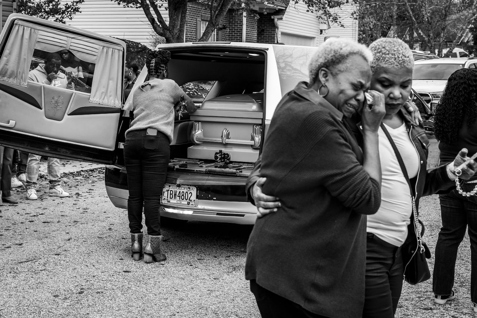 Carroll Brown (left) wipes a tear from her eye after viewing the casket of her son-in-law, Marcus Johnson, 50. Over the past two decades, several of Brown’s family members have had homegoings performed by Willie Watkins Funeral Home.