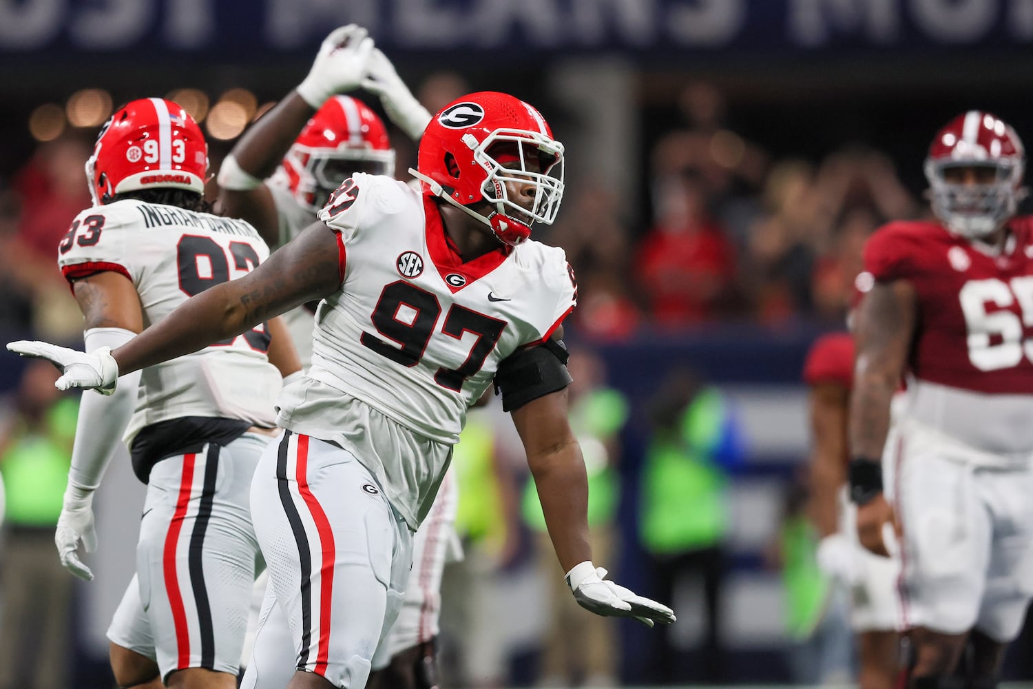 Georgia Bulldogs defensive lineman Warren Brinson (97) reacts after tackling Alabama Crimson Tide quarterback Jalen Milroe during the first half of the SEC Championship football game at the Mercedes-Benz Stadium in Atlanta, on Saturday, December 2, 2023. (Jason Getz / Jason.Getz@ajc.com)