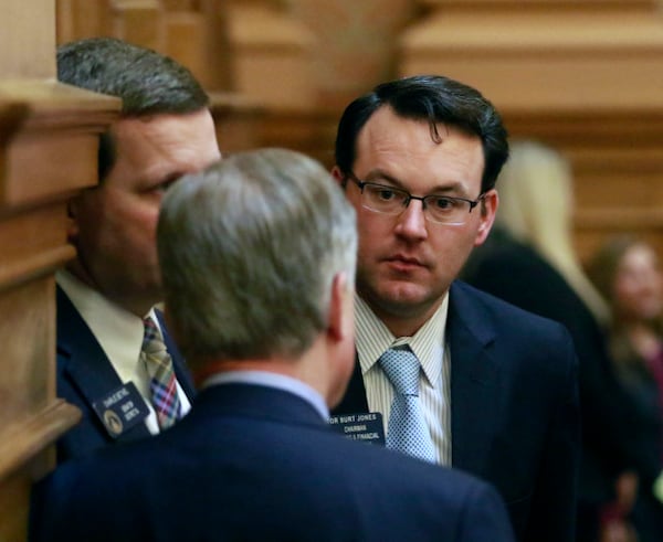 Sen. Burt Jones confers with colleagues on the floor. BOB ANDRES / BANDRES@AJC.COM