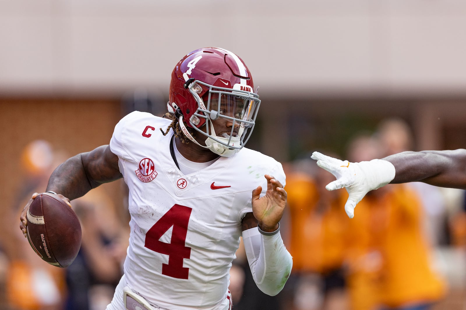 Alabama quarterback Jalen Milroe (4) avoids a Tennessee defender during the first half of an NCAA college football game Saturday, Oct. 19, 2024, in Knoxville, Tenn. (AP Photo/Wade Payne)