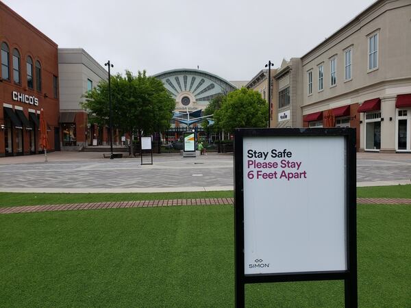 The Mall of Georgia in Gwinnett County and other metro Atlanta malls have re-started operations with new safety measures in places during the coronavirus pandemic. Among the steps are signs to encourage social distancing. MATT KEMPNER / AJC