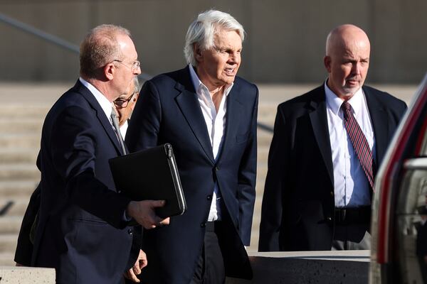 Michael Jeffries, former CEO of Abercrombie & Fitch, center, exits the federal courthouse after his arraignment on sex trafficking and interstate prostitution charges, Friday, Oct. 25, 2024, in Central Islip, N.Y. (AP Photo/Heather Khalifa)