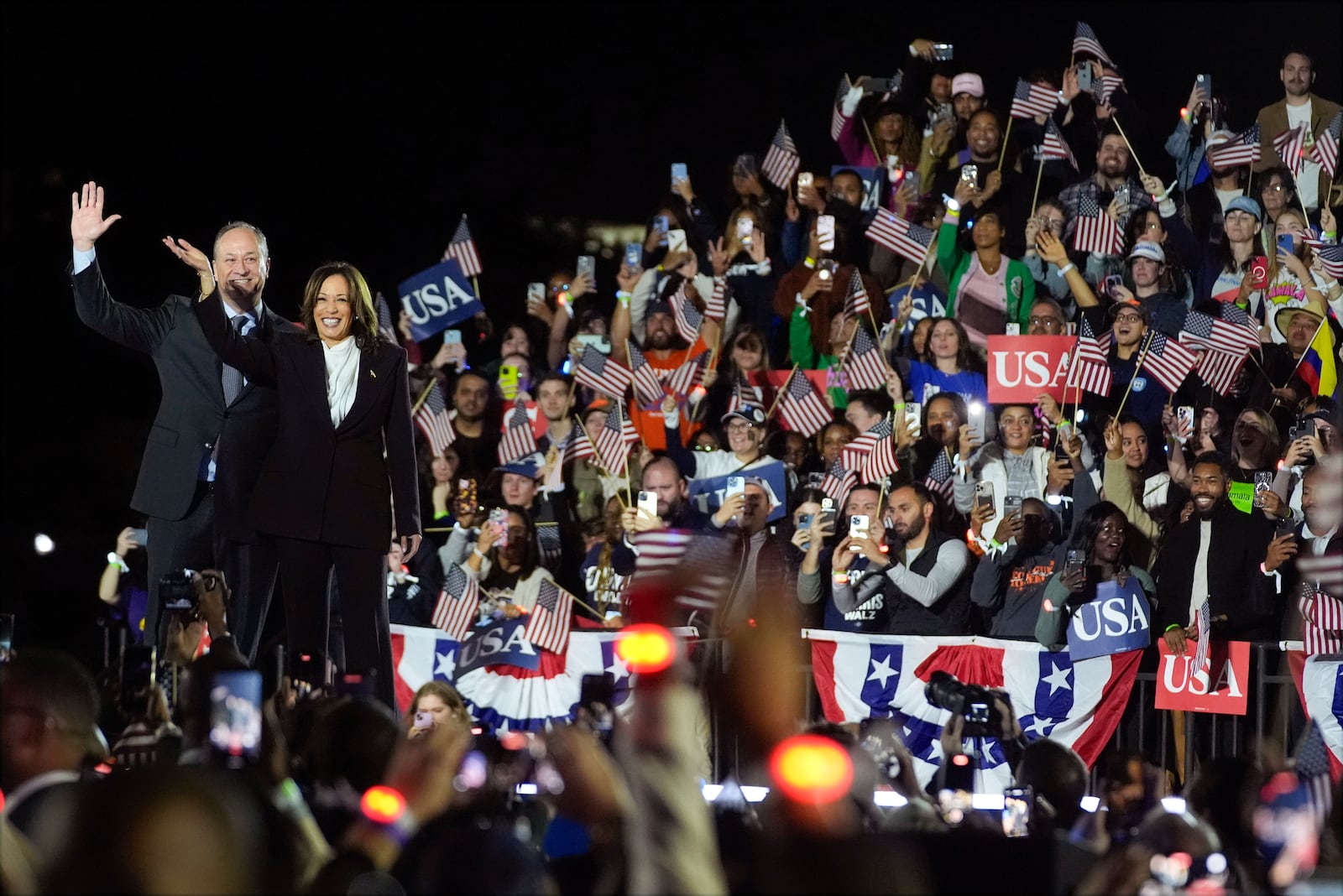 Democratic presidential nominee Vice President Kamala Harris and second gentleman Doug Emhoff wave during a campaign rally on the Ellipse in Washington, Tuesday, Oct. 29, 2024. (AP Photo/Evan Vucci)