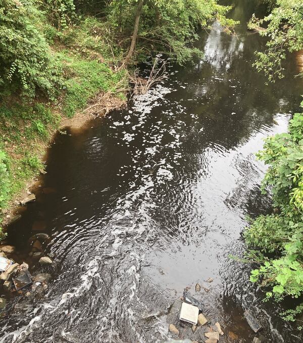 A photo of the South River near Forrest Park Road shows black water flowing on Sept. 6, 2024. State environmental officials have confirmed that they are investigating the pollution incident, which local water advocates say caused a fish kill.