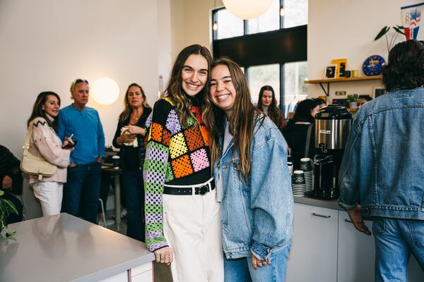 Managers Lauren Kobe (left) and Brooke Libby (right) pose during Warm Waves Coffee's grand opening at the Suwanee location.