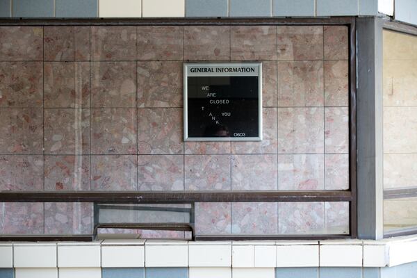 A sign from a closed movie theater still stands in the strip mall. (Casey Sykes for The Atlanta Journal-Constitution)