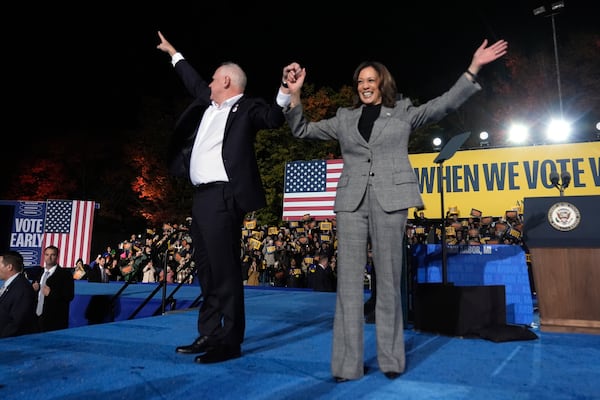 Democratic presidential nominee Vice President Kamala Harris, right, and her running mate Minnesota Gov. Tim Walz depart after speaking during a campaign rally at Burns Park in Ann Arbor, Mich., Monday, Oct. 28, 2024. (AP Photo/Paul Sancya)