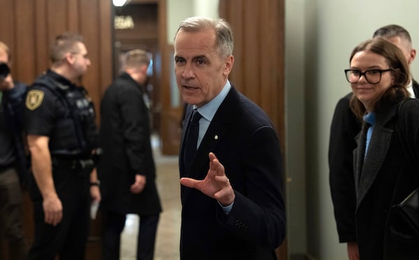 Canada Liberal leader Mark Carney speaks briefly with media before making his way to caucus meeting on Monday, March 10, 2025, in Ottawa. (Adrian Wyld/The Canadian Press via AP)