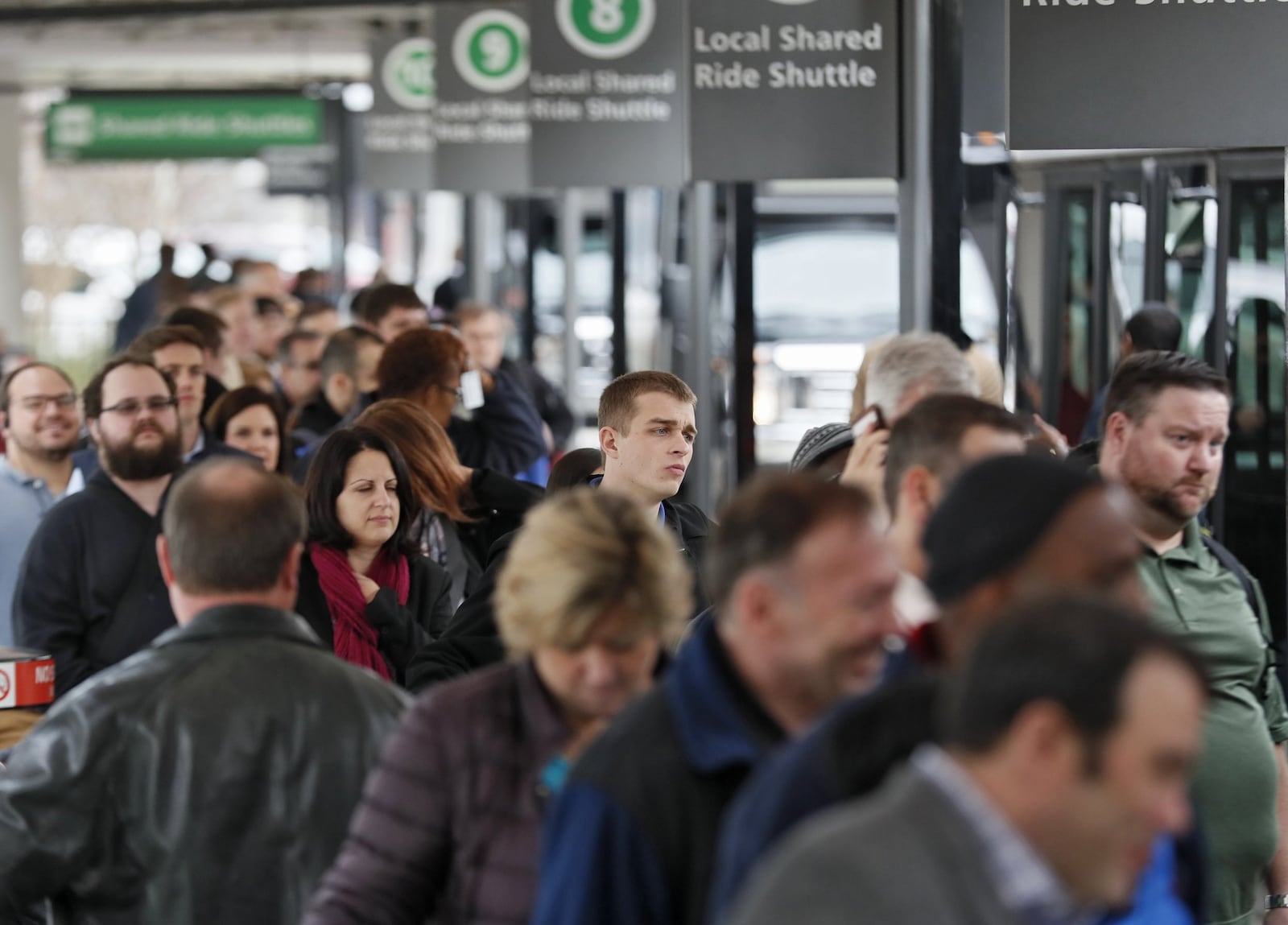 With the SkyTrain out of service, travelers were directed to a long line for shuttle buses. Passengers were still feeling the effects of Sunday’s power outage at Hartsfield-Jackson International Airport in Atlanta as they had to endure long lines to claim baggage and ride shuttles. BOB ANDRES /BANDRES@AJC.COM