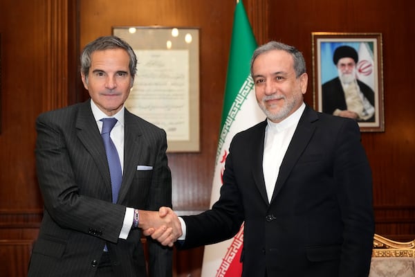 International Atomic Energy Agency (IAEA) Director General Rafael Mariano Grossi, left, shakes hands with Iranian Foreign Minister Abbas Araghchi during their meeting in Tehran, Iran, Thursday, Nov. 14, 2024. (AP Photo/Vahid Salemi)