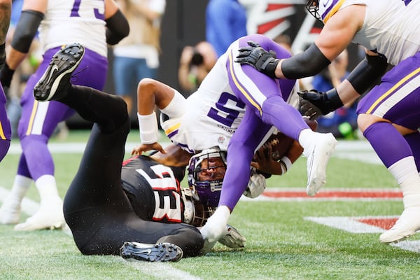 Falcons defensive tackle Calais Campbell (93) sacks Minnesota Vikings quarterback Joshua Dobbs (15) for a safety during the first half on November 5, 2023, at Mercedes-Benz Stadium in Atlanta.  Miguel Martinz/miguel.martinezjimenez@ajc.com