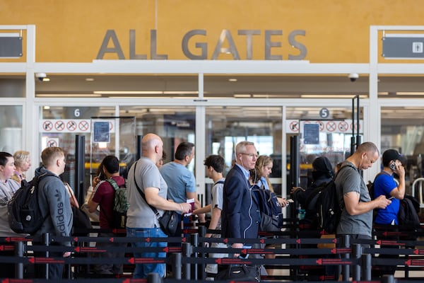 Travelers wait in line for security clearance at the Hartsfield-Jackson airport international terminal in Atlanta on Wednesday, March 27, 2024. (Arvin Temkar / arvin.temkar@ajc.com)