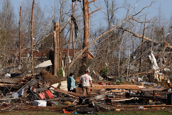 Residents look for personal belongings in the damage after a tornado passed through where two people lost their lives, Sunday, March 16, 2025, in Plantersville, Ala. (AP Photo/Butch Dill)