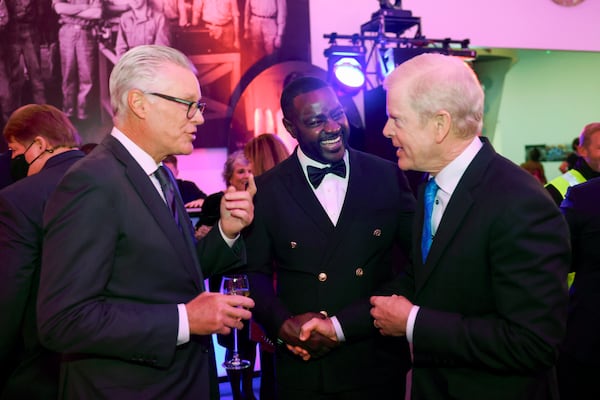 Delta honoree Kelvin Sharpe, center, talks with Delta CEO Ed Bastian, left, and Delta Board of Directors David S. Taylor during the 2024 Delta Chairman’s Club Gala at the Delta Flight Museum on Nov. 21 in Atlanta. (Jason Getz/AJC)
