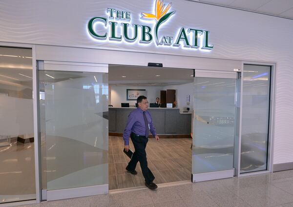 SECOND PHOTO!!! July 17, 2013 - Hapeville: Jorge Cortes walks walk through the doors at The Club at ATL, Hartsfield-Jackson International Airport's first independent VIP passenger lounge, on Wednesday, July 17, 2013. For a $35.00 day pass, passengers receive a shower, alcoholic beverages, snacks, internet access, newspapers and magazines. JOHNNY CRAWFORD / JCRAWFORD@AJC.COM