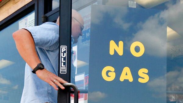 A customer walks into an Exxon filling station and convenience store location where a sign on the door reads, "No Gas," Thursday, Aug. 31, 2017, in Bedford, Texas.