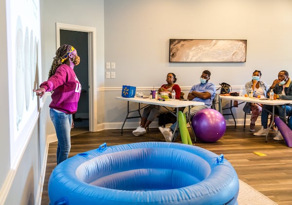 Certified nurse-midwife Christine Taylor, owner of the practice Birth by Grace, holds a birthing class for a few couples in Peachtree City on Saturday, Jan. 23, 2021. The families are planning home births under the guidance of Taylor and doula Dawn Hutcherson.  (Jenni Girtman for The Atlanta Journal-Constitution)