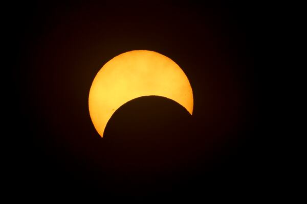 The partial solar eclipse is shown Saturday, October 14, 2023, in Peachtree Corners, Ga. Georgians were able to capture a glimpse of the moon passing between the sun and the earth. It started around noon and lasted several hours. (Jason Getz / Jason.Getz@ajc.com)