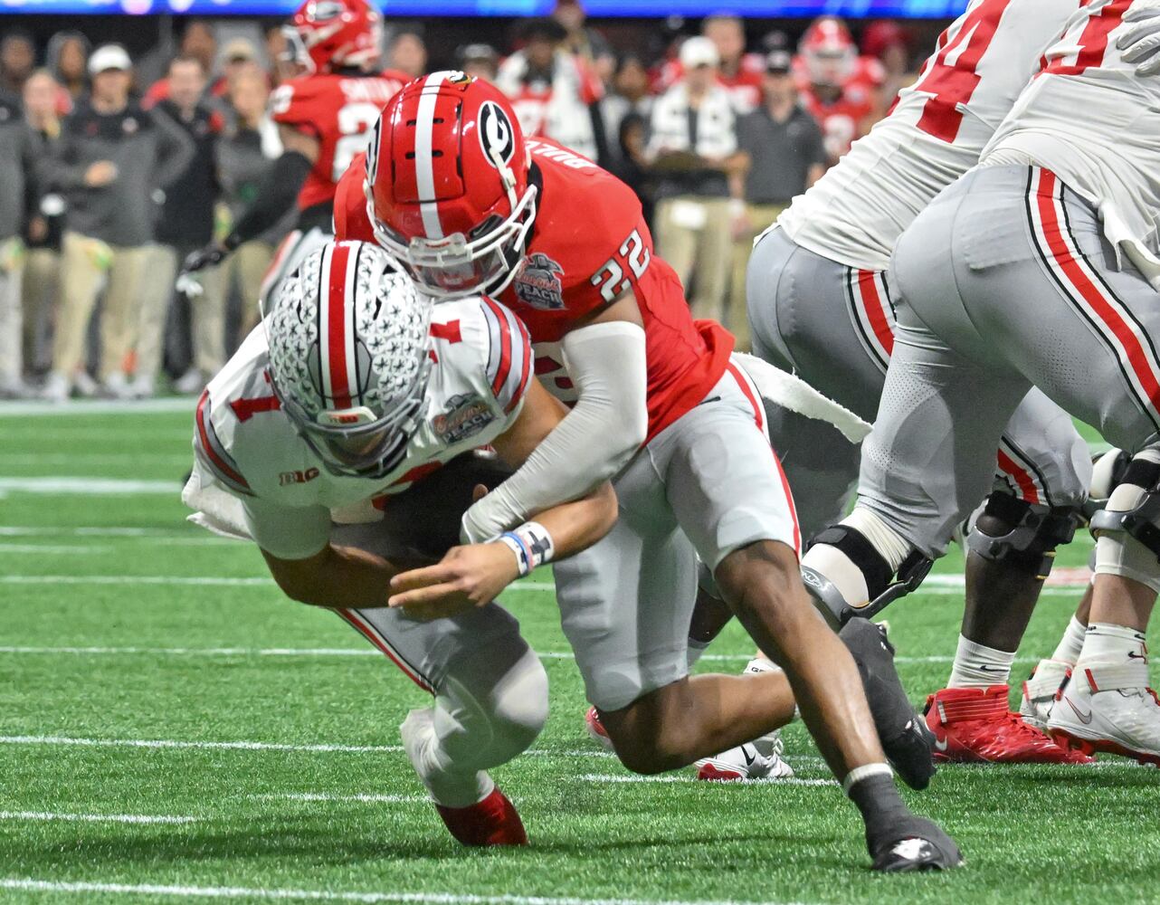 Georgia Bulldogs defensive back Javon Bullard (22) sacks Ohio State Buckeyes quarterback C.J. Stroud (7) during the third quarter of the College Football Playoff Semifinal between the Georgia Bulldogs and the Ohio State Buckeyes at the Chick-fil-A Peach Bowl In Atlanta on Saturday, Dec. 31, 2022. (Hyosub Shin / Hyosub.Shin@ajc.com)