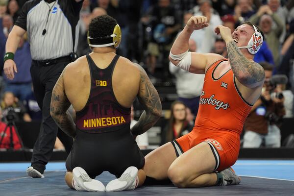 Oklahoma State's Wyatt Hendrickson, right, reacts after defeating Minnesota's Gable Steveson during a 285-pound match in the finals at the NCAA wrestling championship, Saturday, March 22, 2025, in Philadelphia. (AP Photo/Matt Rourke)