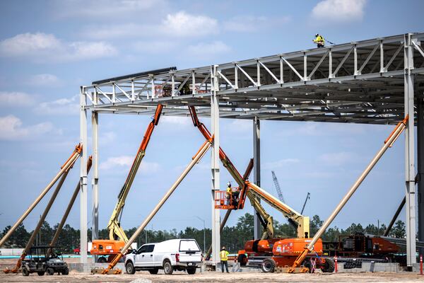 ELLABELL, GA. - JUNE 5, 2023: A worker walks along the newly installed roof of the Hyundai Mobis building, Monday, June 5, 2023, in Ellabell, Ga. (AJC Photo/Stephen B. Morton)