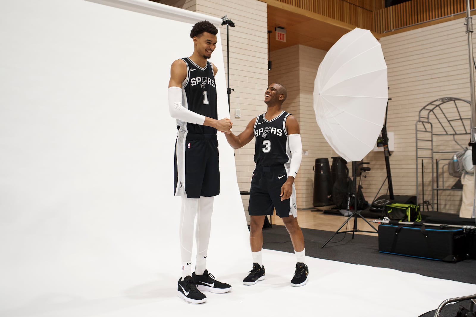 San Antonio Spurs players Victor Wembanyama (1) and Chris Paul (3) pose for photos during the NBA basketball team's media day, Monday, Sept. 30, 2024, in San Antonio. (AP Photo/Darren Abate)