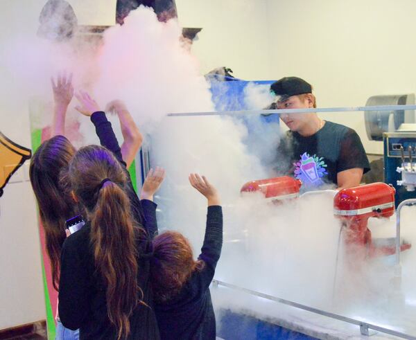 Young customers enjoy the excitement of liquid nitrogen ice cream being made at Roll It Up. CONTRIBUTED BY HENRI HOLLIS