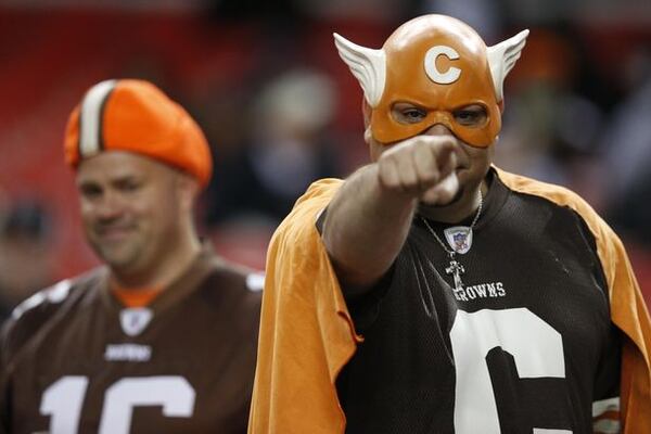 Cleveland Browns fans watch the teams warm up before the first half of an NFL football game against the Atlanta Falcons, Sunday, Nov. 23, 2014, in Atlanta. (AP Photo/Brynn Anderson )