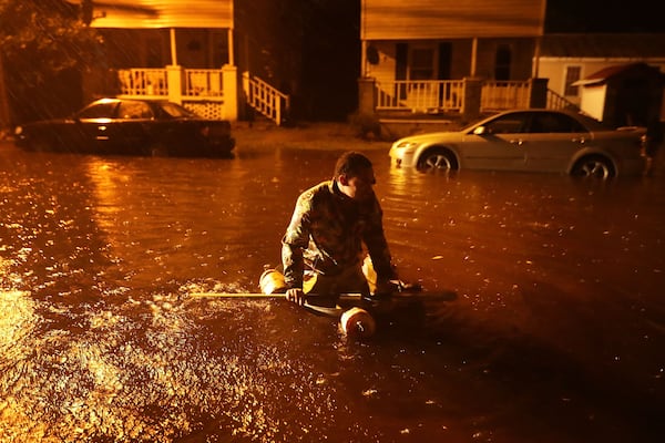  Michael Nelson floats in a boat made from a metal tub and fishing floats after the Neuse River went over its banks and flooded his street during Hurricane Florence Friday  in New Bern, N.C.  (Photo: Chip Somodevilla/Getty Images) 