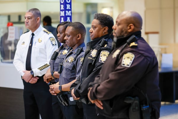 Fulton County officers, including Chief Deputy Curtis Clark, (white uniform) participated in a moment of silence in honor of the victims who died 20 years ago at the Fulton County Courthouse. 
(Miguel Martinez/ AJC)