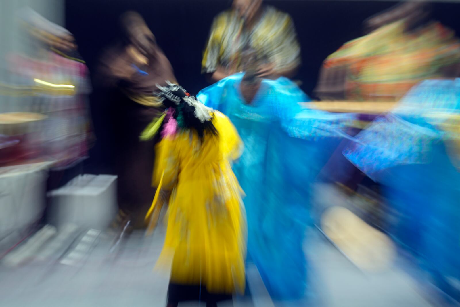 In this image taken with a slow shutter speed, Sudanese Camirata troupe dancers perform a "Al Hamal Rakd" dance from West Sudan, during a show at the Russian culture center in Cairo, Egypt, Sunday, Sept. 15, 2024. (AP Photo/Amr Nabil)