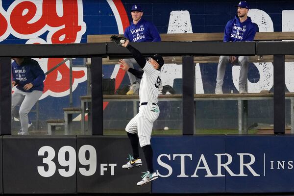 New York Yankees center fielder Aaron Judge catches a fly ball by Los Angeles Dodgers' Freddie Freeman during the fourth inning in Game 5 of the baseball World Series, Wednesday, Oct. 30, 2024, in New York. (AP Photo/Seth Wenig)