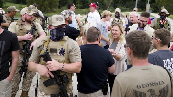 Armed members of the Georgia III% Martyrs surround congressional candidate Marjorie Taylor Greene as she meets with supporters during a gun rights rally in September at the Northwest Georgia Amphitheatre in Ringgold. Staff photo by C.B. Schmelter