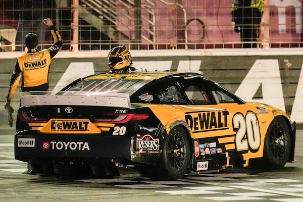 Christopher Bell (20) celebrates his victory after a NASCAR Cup Series auto race, Sunday, Feb. 23, 2025, in Hampton, Ga. (AP Photo/Mike Stewart)