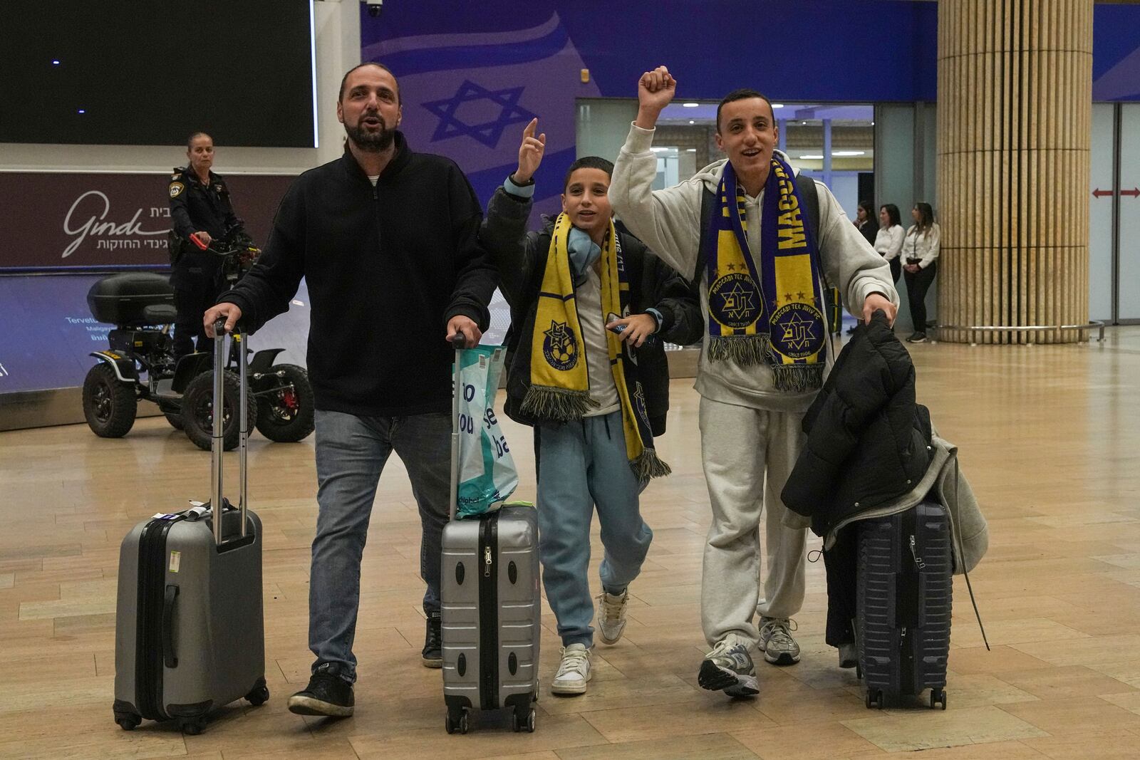 Maccabi Tel Aviv soccer fans arrive at Israel's Ben-Gurion International Airport on a flight from Amsterdam, where Israeli soccer fans were attacked following a match between the Israeli club and Ajax Amsterdam, in Lod, Israel, Friday, Nov. 8, 2024. (AP Photo/Tsafrir Abayov)