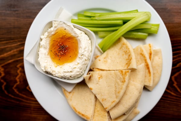 Whipped Feta snack for sharing with local honey and warm pita. Photo credit- Mia Yakel.