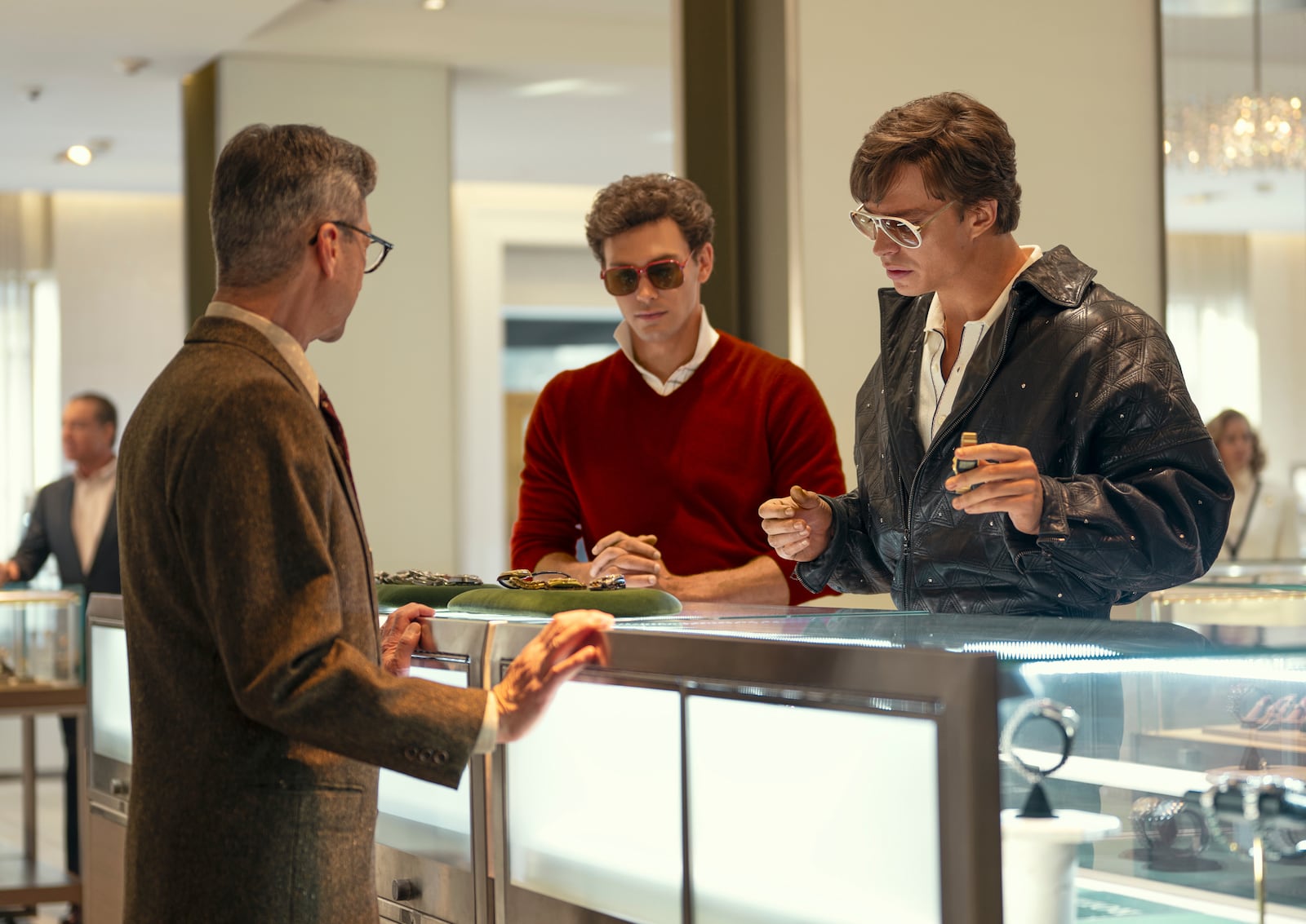 This image released by Netflix shows Cooper Koch as Erik Menendez, center, and Nicholas Chavez as Lyle Menendez, right, in a scene from "Monsters: The Lyle And Erik Menendez Story." (Miles Crist/Netflix via AP)