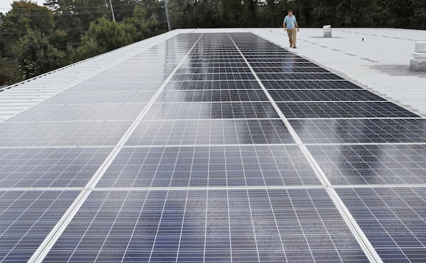 Scott Starowicz, SAE’s chief financial officer, walks past the school’s solar panel array. The pre-K-8 school in Mableton is believed to be the first elementary school in the state with plans to be powered 100% by solar energy. Sustainability efforts are integrated into the school’s curriculum. BOB ANDRES / ROBERT.ANDRES@AJC.COM