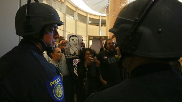 Helmeted Sacramento police officers block the entrance to the Sacramento City Council chambers Tuesday, March 27, 2018, as demonstrators protest the shooting death of Stephon Clark. Clark, 22, died March 18 after two officers fired 20 rounds at him as he stood, unarmed, on the back patio of his grandparents' home.