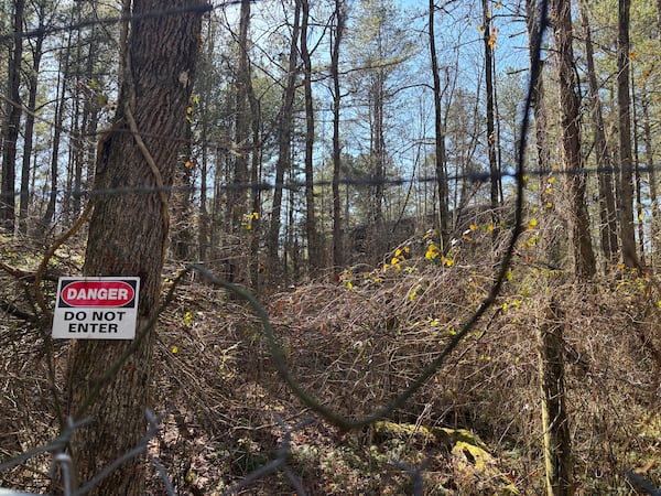 Before Atlanta acquired the Dawson Forest, it had been used by the then-Lockheed-Georgia Co. as a test site for nuclear-powered aircraft. 

One of the project's structures remains standing and hidden behind barbed wire. Radiation levels are safe, according to Georgia EPD. (Emma Hurt/AJC)