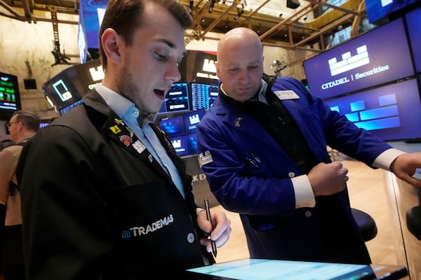 Traders work on the floor of the New York Stock Exchange, Wednesday, March 12, 2025. (AP Photo/Richard Drew)