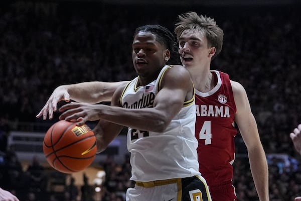 Purdue guard Gicarri Harris (24) is fouled by Alabama forward Grant Nelson (4) during the first half of an NCAA college basketball game in West Lafayette, Ind., Friday, Nov. 15, 2024. (AP Photo/Michael Conroy)