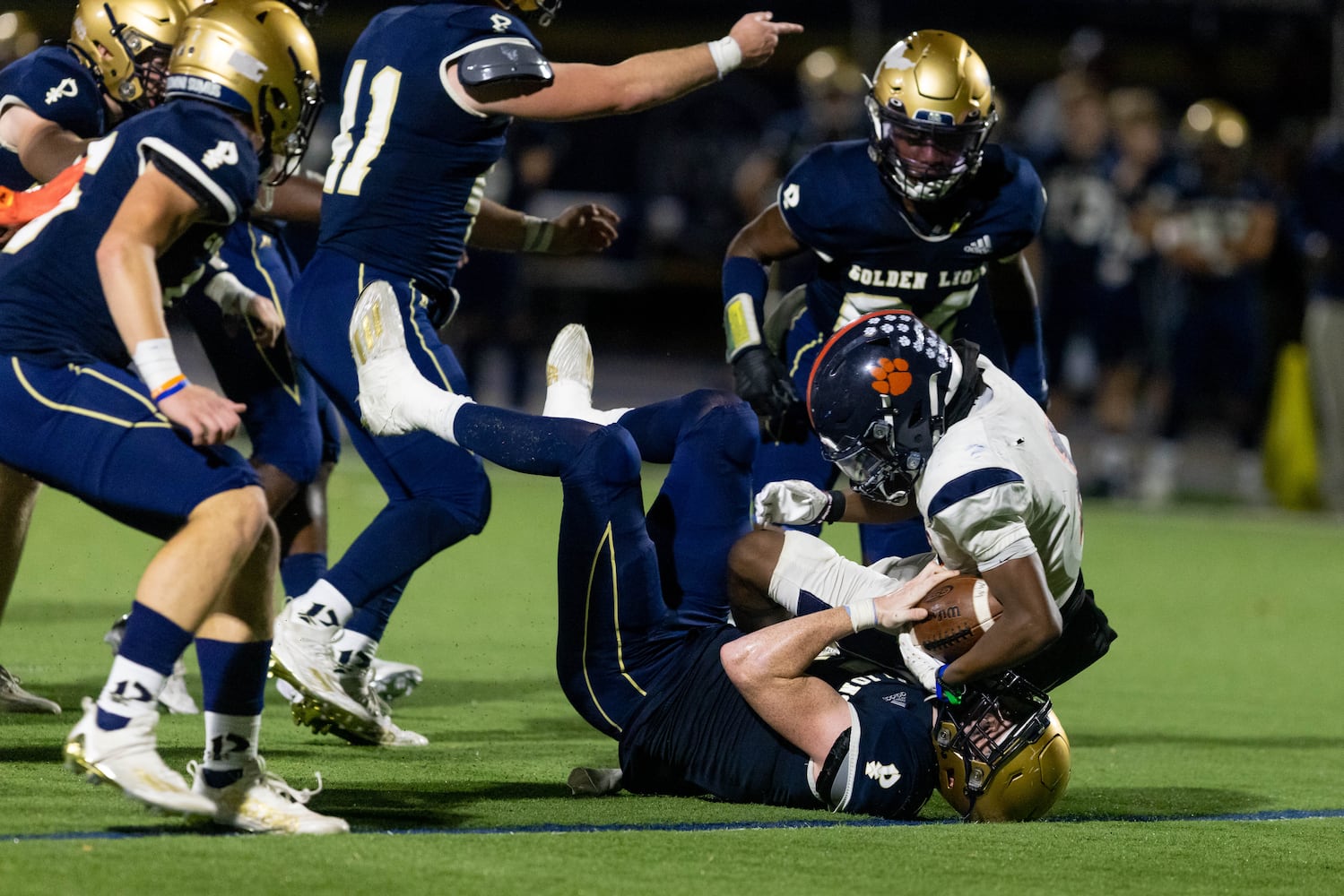 Mundy's Mill’s Dajuan Springer (1) is tackled by St. Pius’ Liam Whitlark (5) during a GHSA High School football game between St. Pius and Mundy’s Mill at St. Pius Catholic School in Atlanta, GA, on Friday, November 11, 2022.(Photo/Jenn Finch)