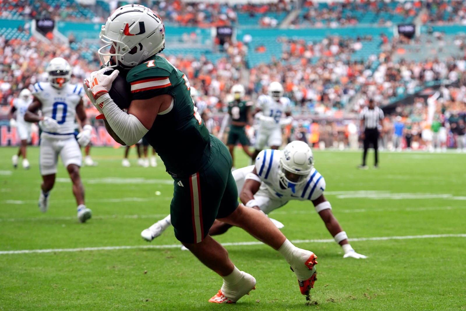 Miami wide receiver Xavier Restrepo (7) makes a catch for a touchdown during the first half of an NCAA college football game against Duke, Saturday, Nov. 2, 2024, in Miami Gardens, Fla. (AP Photo/Lynne Sladky)