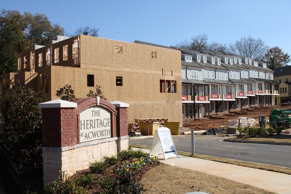 Views of the ongoing townhome development Heritage in Acworth in the city's downtown, built by prominent Atlanta home builder John Wieland, as seen on Friday, Nov. 4, 2022. Wieland and the city are being sued by the homeowner of an adjacent property.